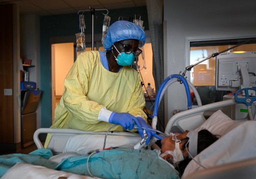 Registered nurse Jane Abas tends to a COVID-19 variant patient who is intubated and on a ventilator in the intensive care unit at the Humber River Hospital during the COVID-19 pandemic in Toronto on Tuesday, April 13, 2021.