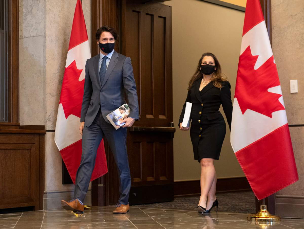 Prime Minister Justin Trudeau, left, arrives with Deputy Prime Minister and Minister of Finance Chrystia Freeland as she prepares to table the federal budget in the House of Commons in Ottawa, on Monday, April 19, 2021. 
