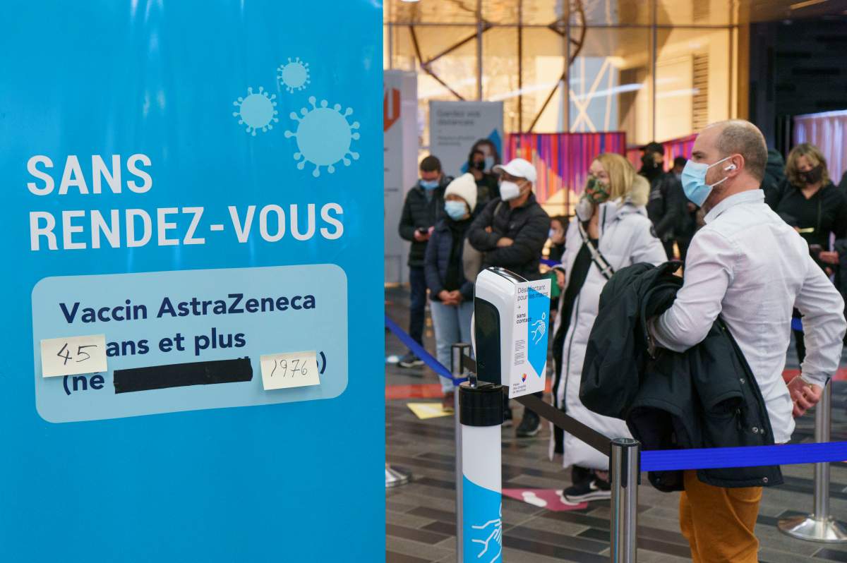 People line up at walk-in COVID-19 vaccination clinic to receive the AstraZeneca vaccine in Montreal, on Wednesday, April 21, 2021. Quebecers 45 and over can now get the AstraZeneca vaccine across the province.