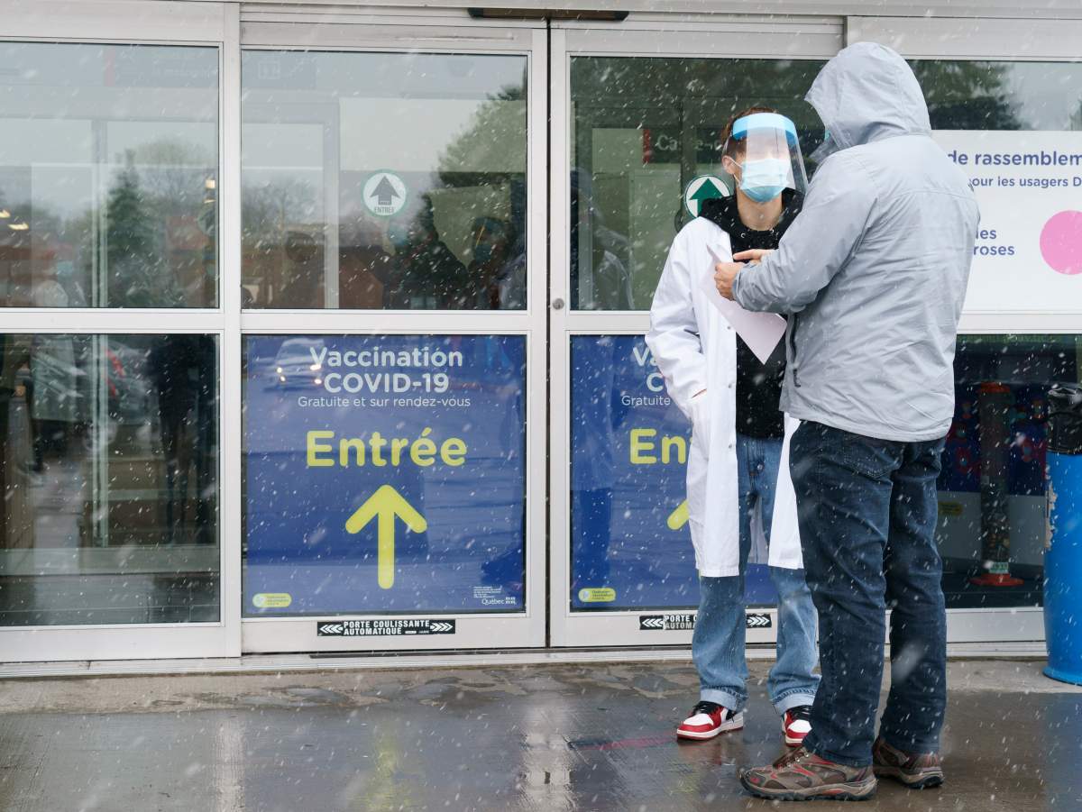 A man is screened before entering a COVID-19 vaccination clinic in Montreal, on Wednesday, April 21, 2021.