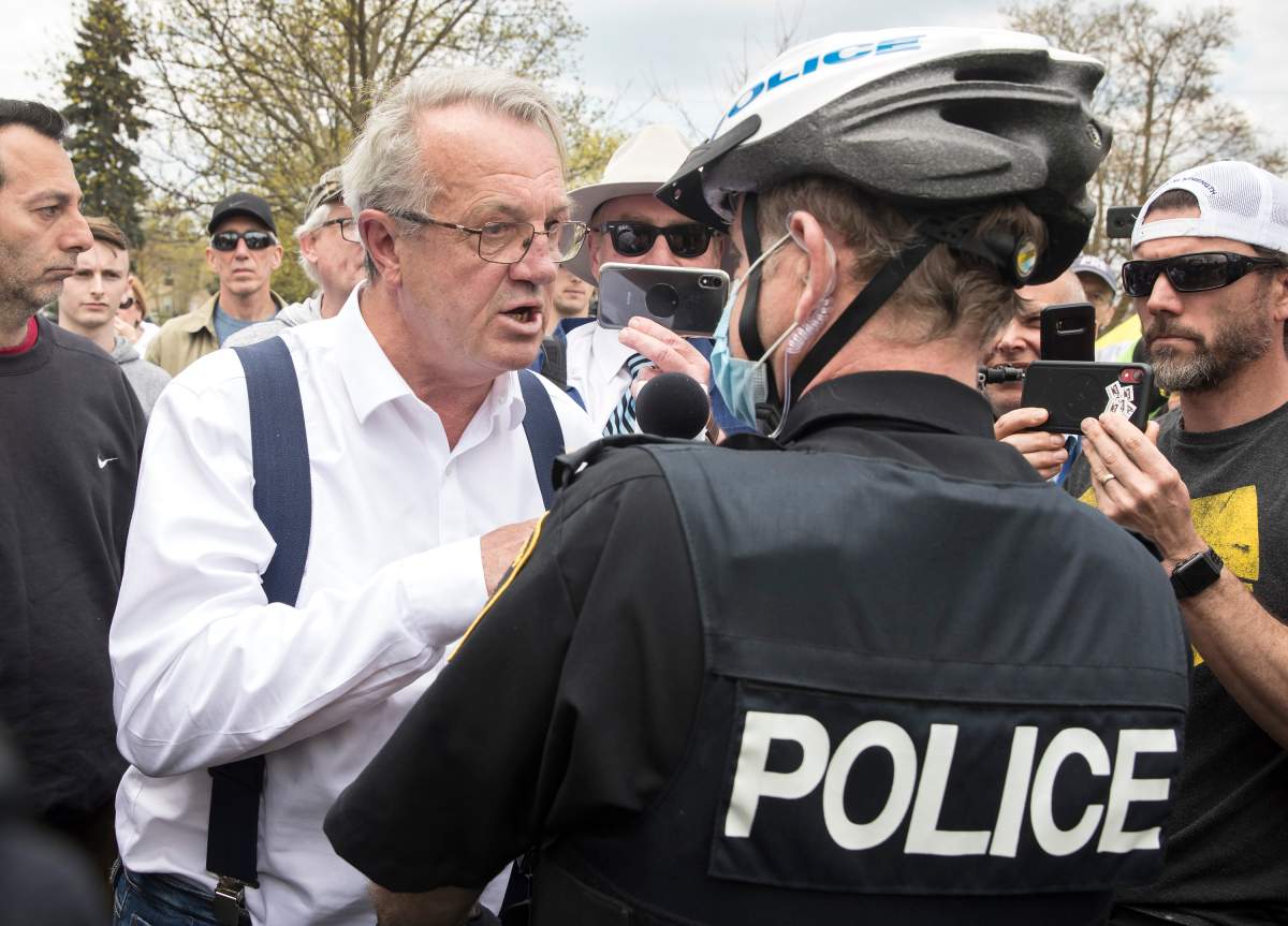 Randy Hillier, independent MPP for Lanark-Frontenac-Kingston argues with Peterborough Police Service Chief Scott Gilbert at an anti-lockdown protest against government measures to curb the spread of COVID-19, in Peterborough, Ont., Saturday, April 24, 2021. Hillier received a ticket and a summons to appear in court for violating the province's stay-at-home-order. 