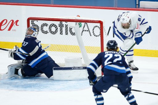 Toronto Maple Leafs’ Joe Thornton (97) scores on the wraparound against Winnipeg Jets goaltender Connor Hellebuyck (37) during first period NHL action in Winnipeg on Saturday, April 24, 2021.