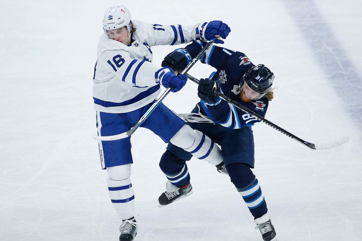 Winnipeg Jets’ Kyle Connor (81) and Toronto Maple Leafs’ Mitchell Marner (16) collide during first period NHL action in Winnipeg on Saturday, April 24, 2021.