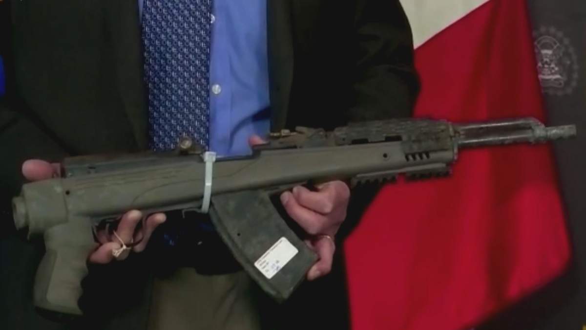 Calgary police hold the semiautomatic rifle believed to have been used in a 2019 double homicide.