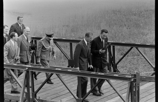 Prince Philip, Duke of Edinburgh walking on a dock during the British Empire and Commonwealth Games, Vancouver, B.C., 1954.