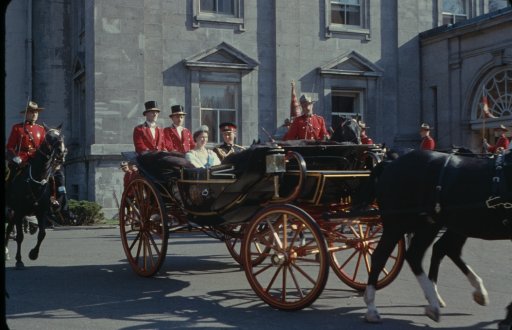 Queen Elizabeth II and Prince Philip riding in a carriage together with the royal guards, Ontario, Canada, October 1957.