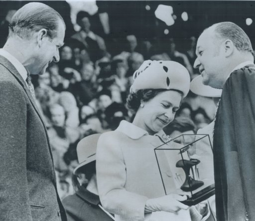 May 6, 1971: Queen Elizabeth II and Prince Philip admire a glass-enclosed sculpture presented to them by Mayor Hilbert Roth (right) during their visit in Kelowna, B.C.