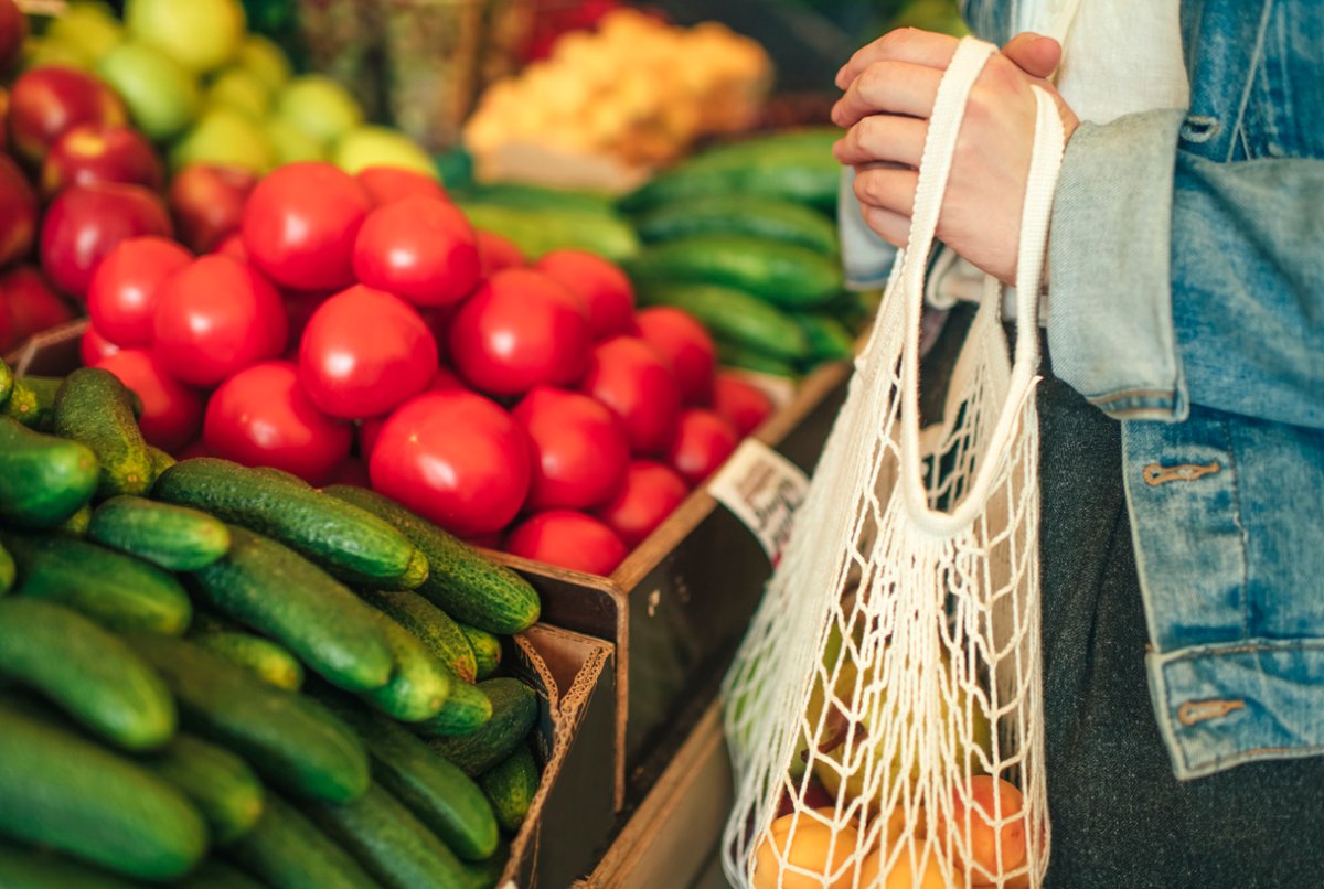 shopping for produce with a reusable bag