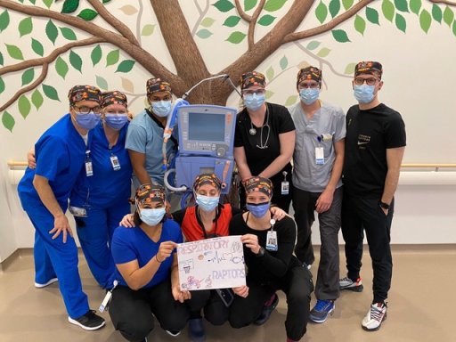 Keanna Alcock (bottom row on the right) poses alongside her masked coworkers, who she credits with having helped her adjust into a new role early in the pandemic.