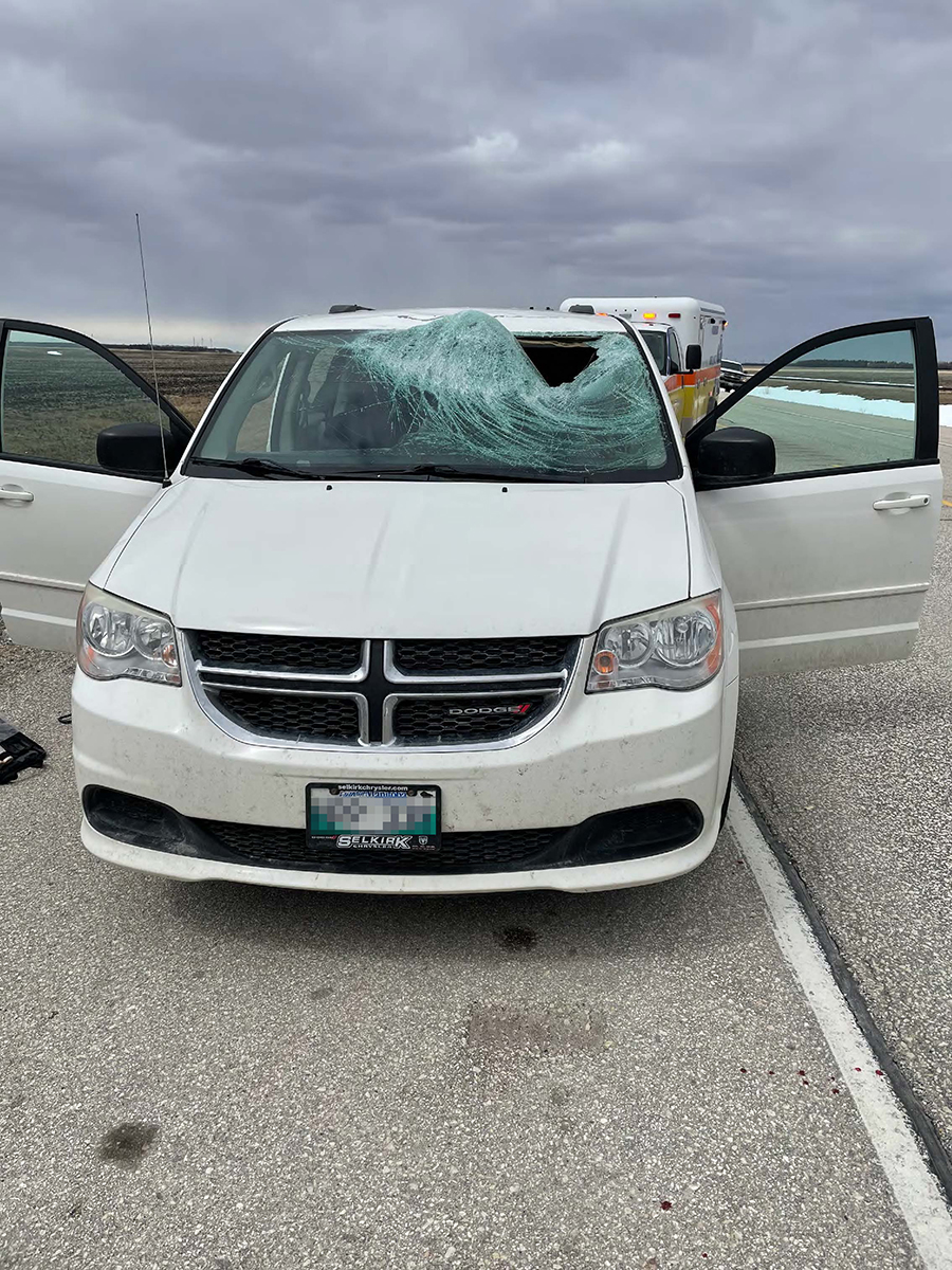 A chunk of ice went through the windshield of this van, striking the driver and knocking him unconscious.