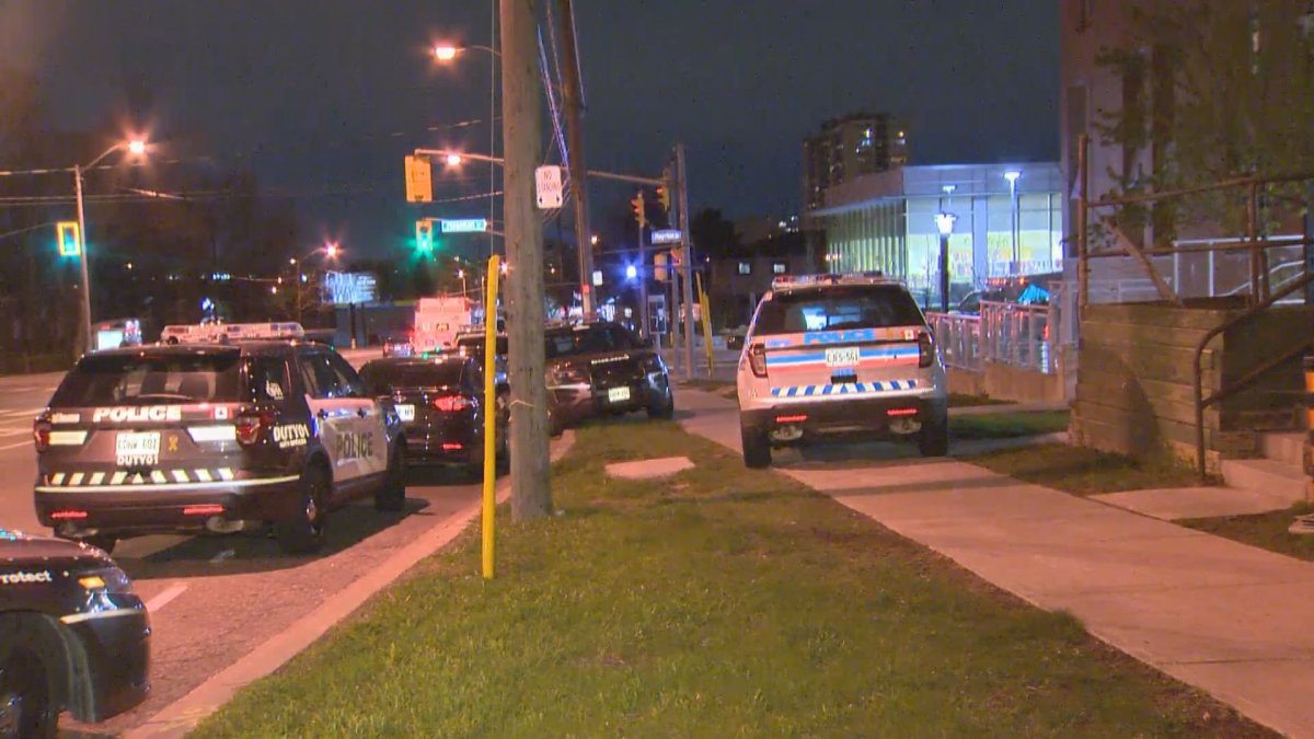 A photo of police cruisers outside a Toronto apartment building following a shooting.