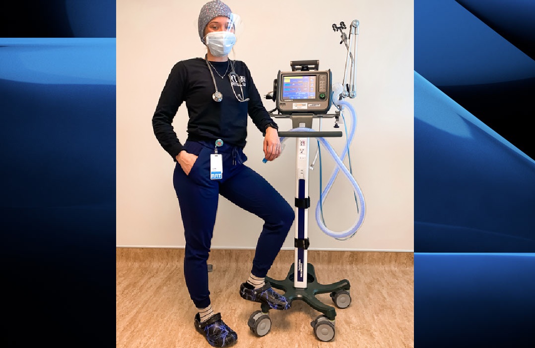 Respiratory therapist Keanna Alcock stands alongside a ventilator, a machine that has accompanied her on her journey from aspiring medical professional to a bonafide healthcare hero.
