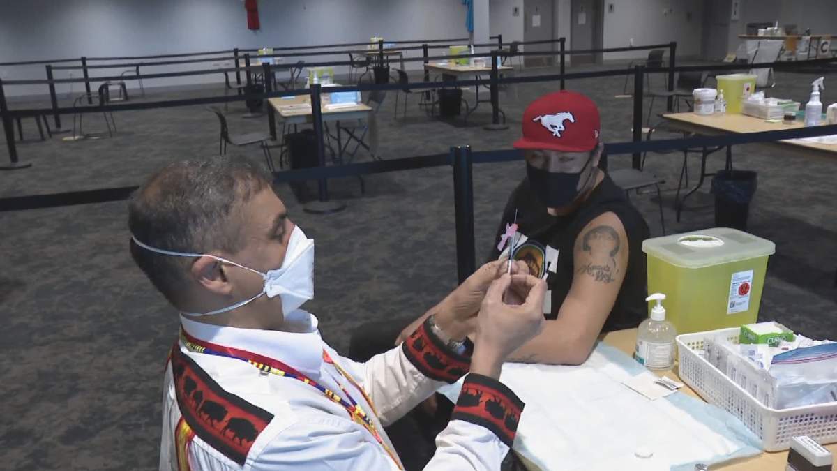 A person waits to get their COVID-19 vaccine at Calgary's second Indigenous vaccine clinic on Wednesday, April. 14. 