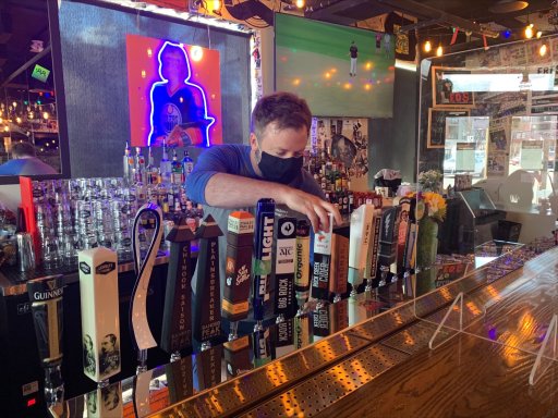 A bartender at Leopold’s Tavern on Whyte Avenue pours a pint on April 9, 2021.