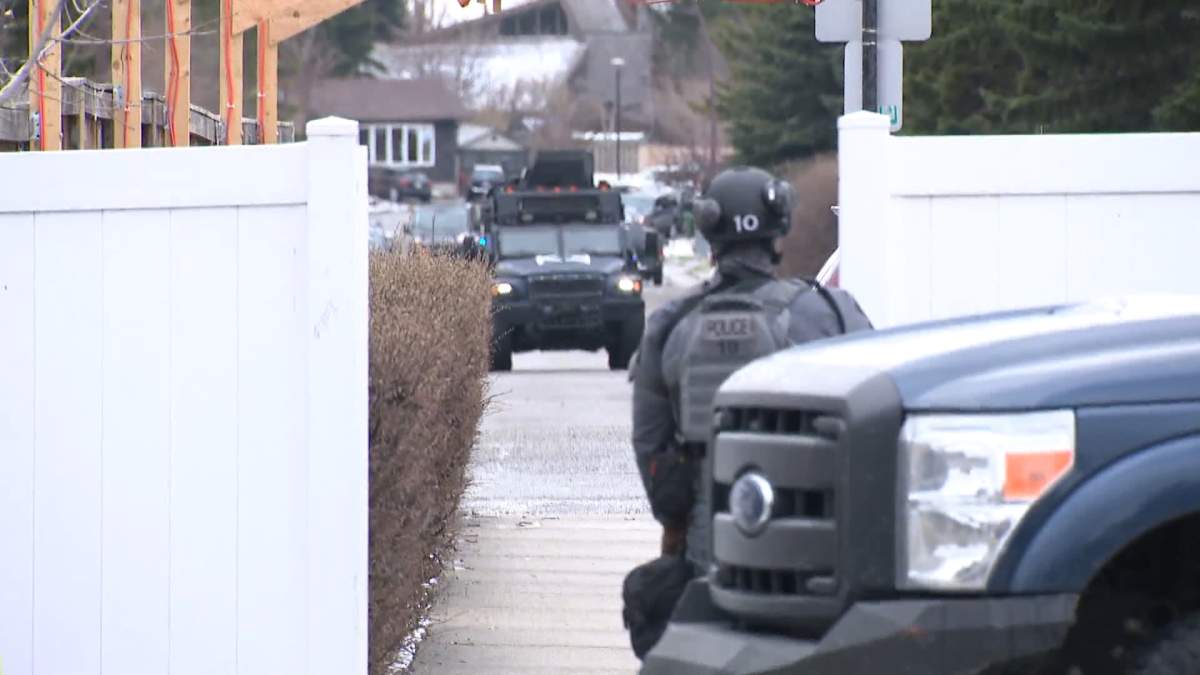 An armoured tactical vehicle is seen at the scene of a standoff in northeast Calgary.