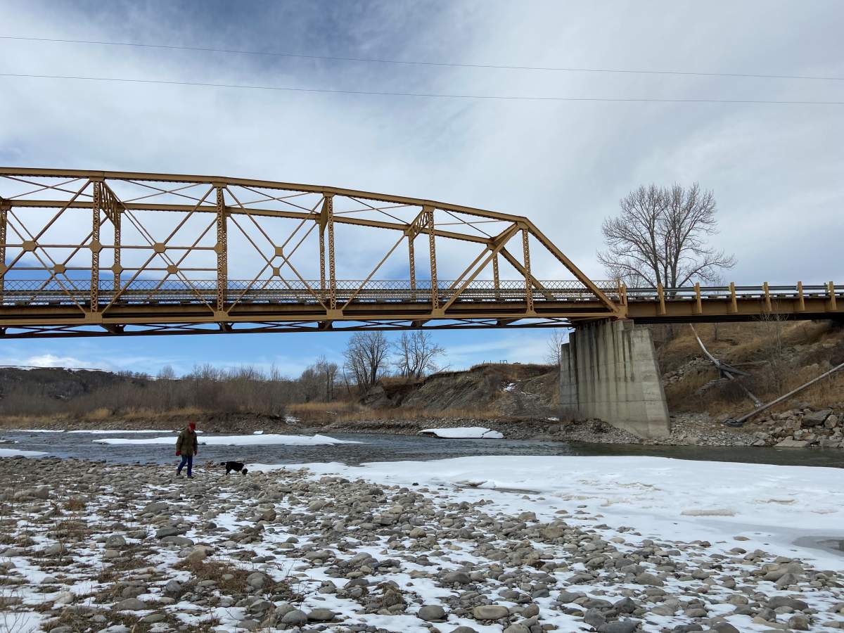 John Lawson walking along the Oldman River.