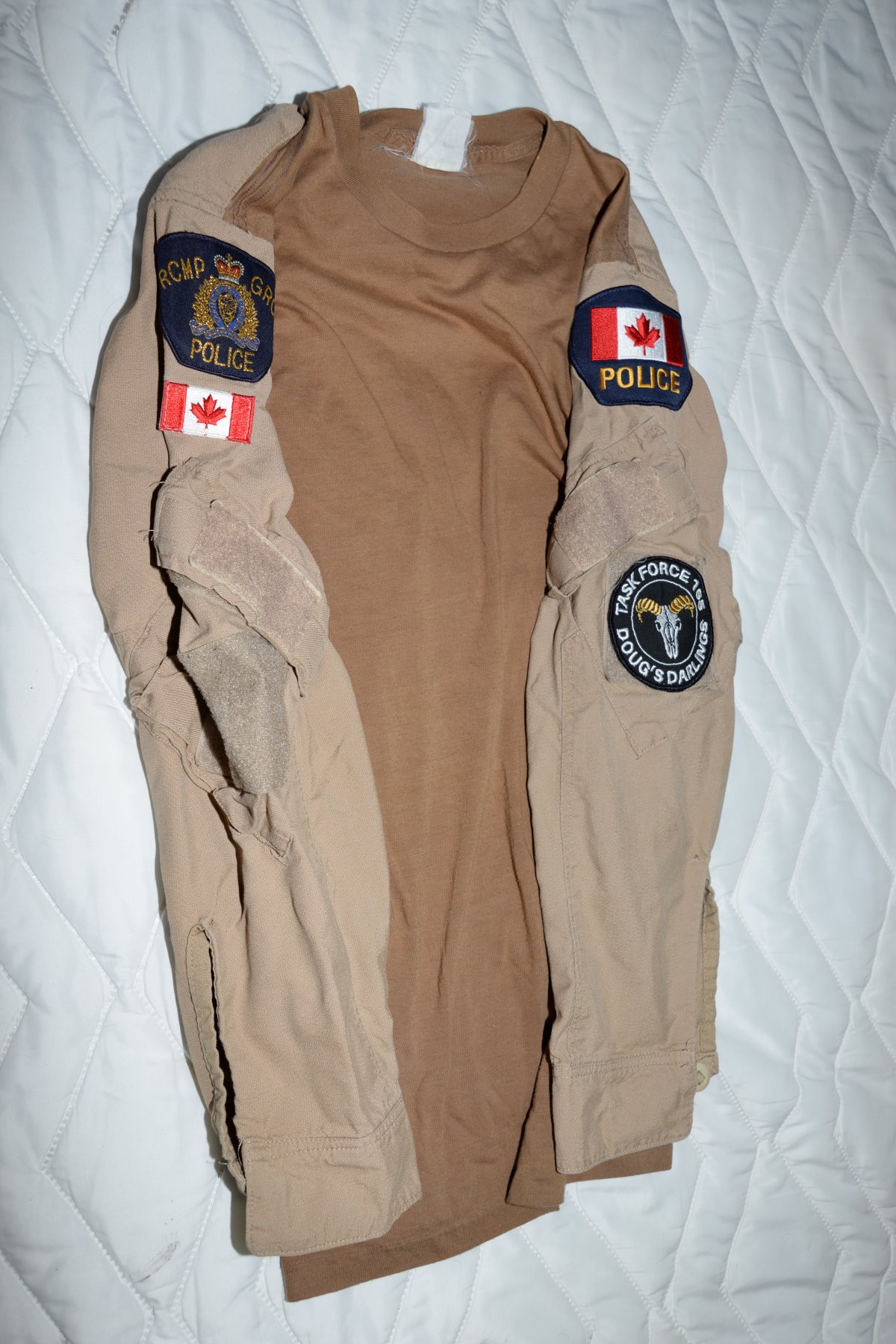 A sweater with RCMP patches on it seized by the Alberta RCMP Integrated National Security Enforcement Teams in Parkland County in February 2021.