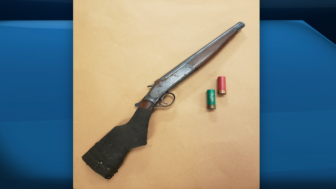 A 12-gauge sawed-off shotgun and two shotgun shells seized by London police on April 28, 2021.