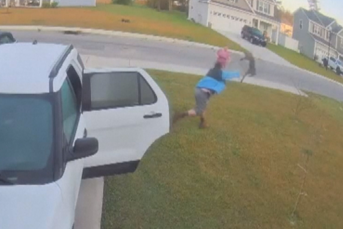 Happy wade hurls an unhappy bobcat across his yard after it attacked his wife in Burgaw, N.C., on April 9, 2021.