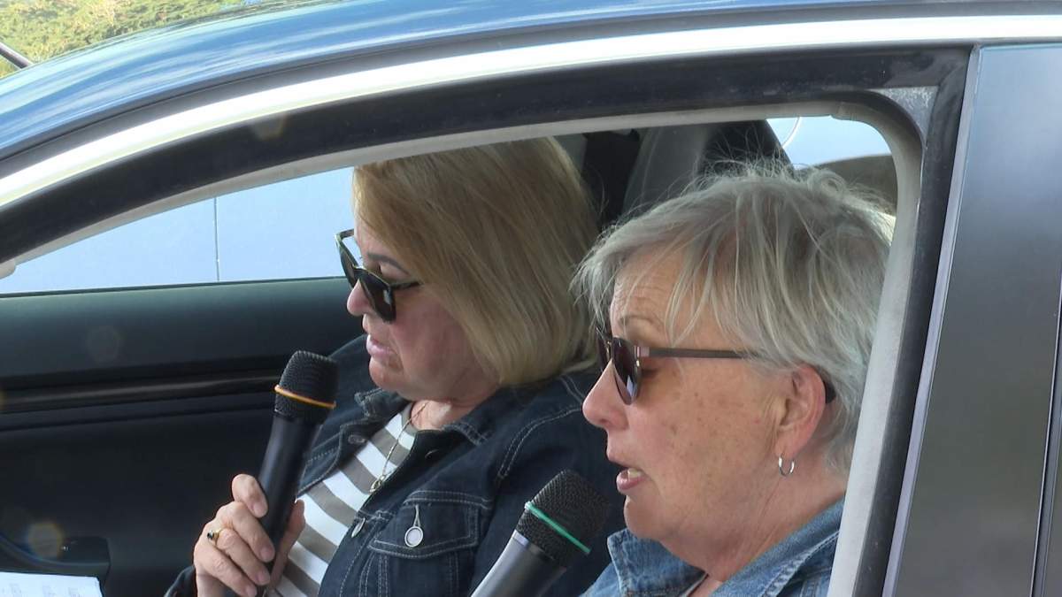 Two members of the Vernon Kalamalka Chorus  singing in their car.