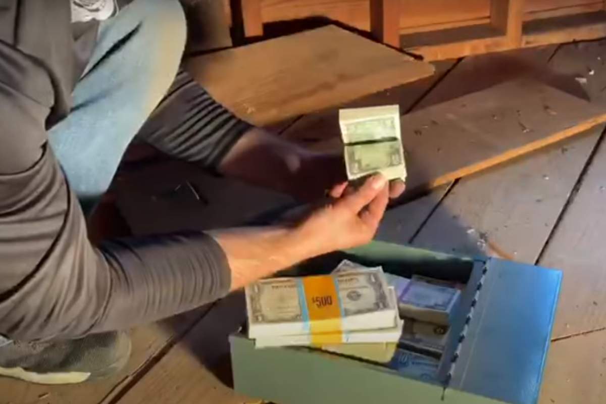 Treasure hunter Keith Wille shows off the cash he found in a New England home. 