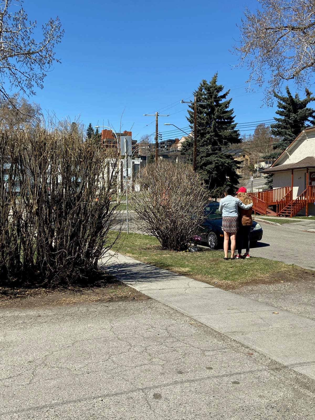 Mourners seen at the scene of a suspected impaired driving collision that left a man dead in northeast Calgary on Tuesday.