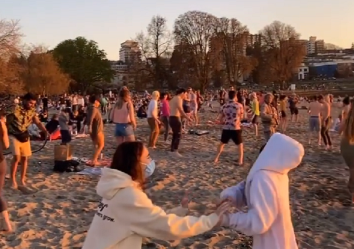 Still images from video posted to Instagram shows people, some of them without masks, dancing in groups on Vancouver’s Kits Beach.