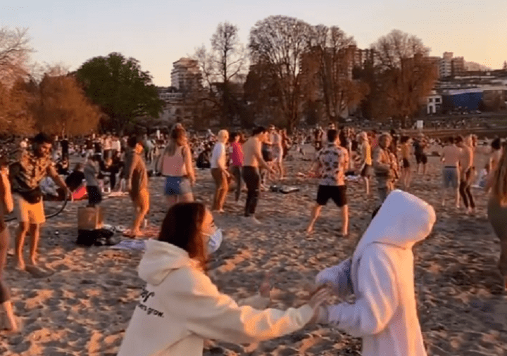 Still images from video posted to Instagram shows people, some of them without masks, dancing in groups on Vancouver’s Kits Beach.