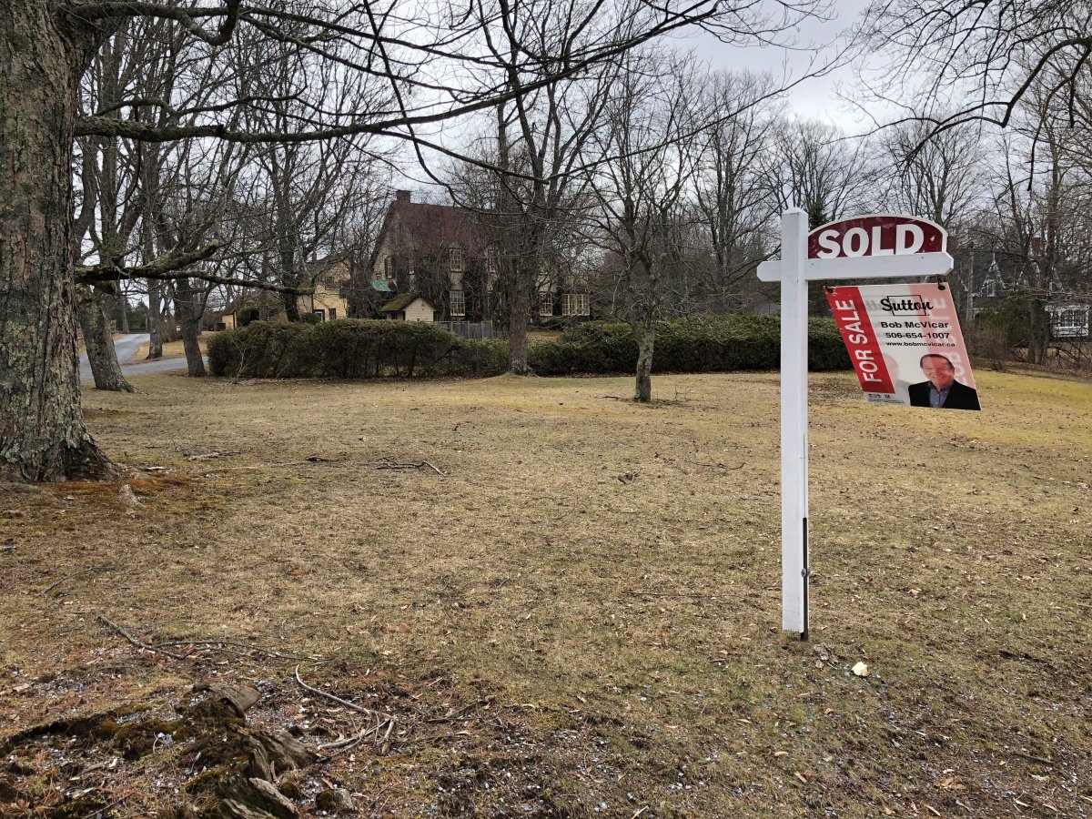 A 'sold' sign is seen in front of Dennis Oland's family home in Rothesay, N.B.