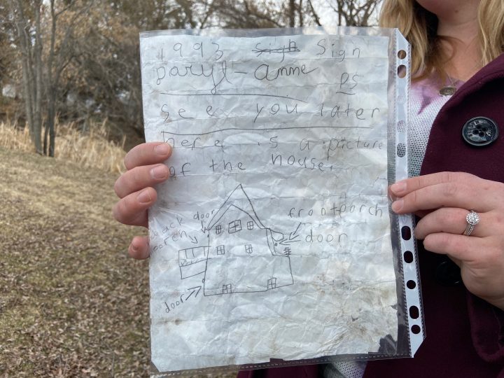 Michelle Schwengler holds up the message she found in a bottle.