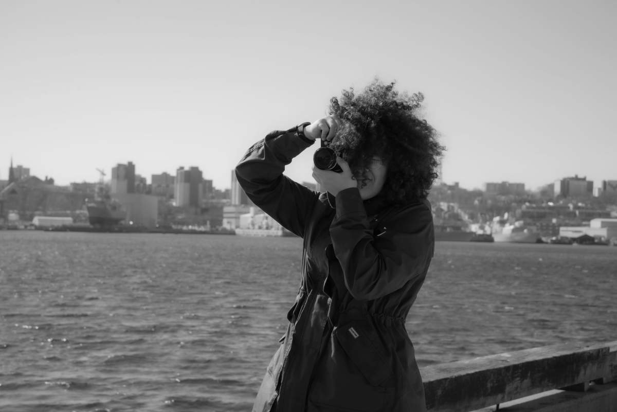 Rae RezWell is a Dominican-Canadian mixed-media photographer who uses American Sign Language (ASL) to communicate.