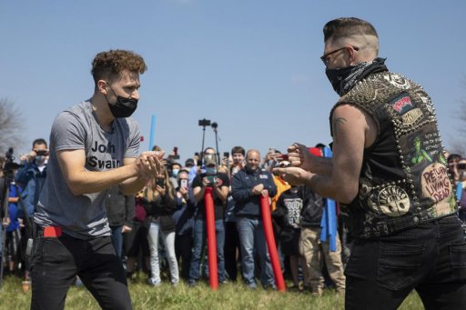Josh Swain, left, the originator of the joke, takes on another Josh as they decide the rightful owner of the name Josh via a game of rock, paper, scissors in an open green space in Air Park on Saturday, April 24, 2021, in Lincoln, Neb.