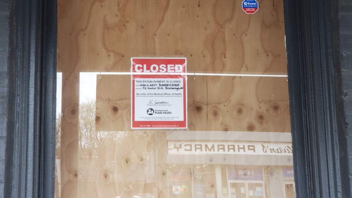 Signage on the front of Who\’s Next BarberShop on Hunter St.