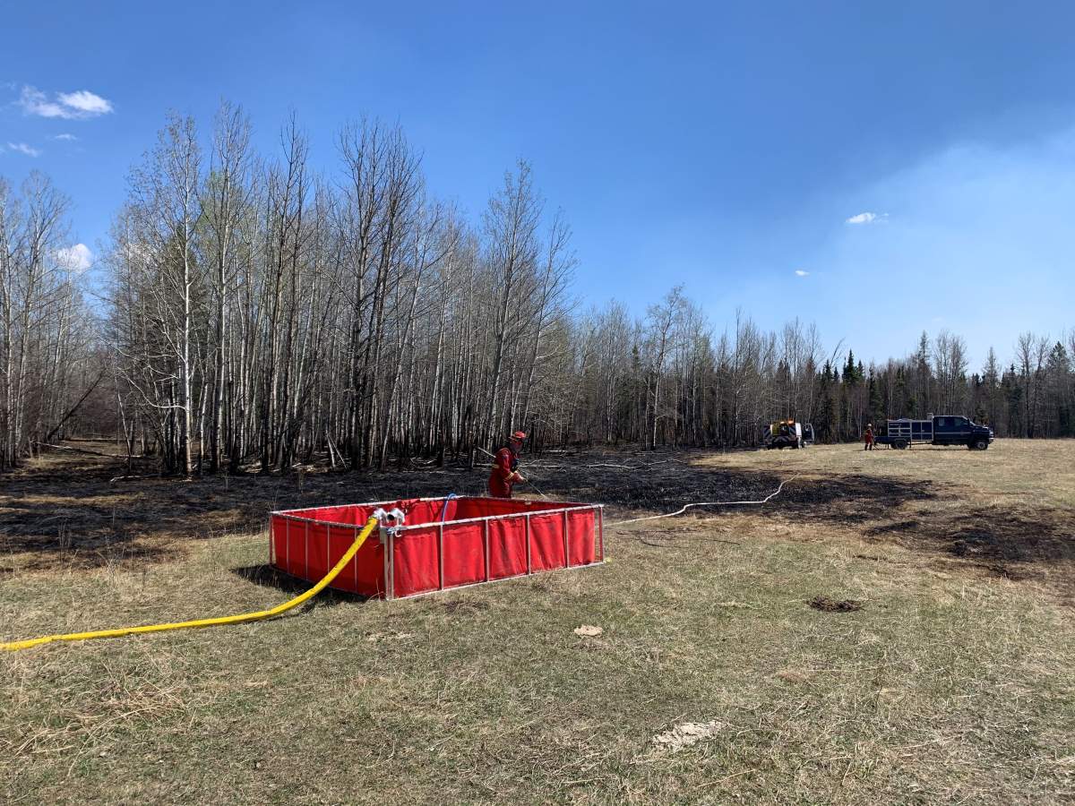 Allan Roberts surveys the fire damage to his Tomahawk property on May 10, 2021.