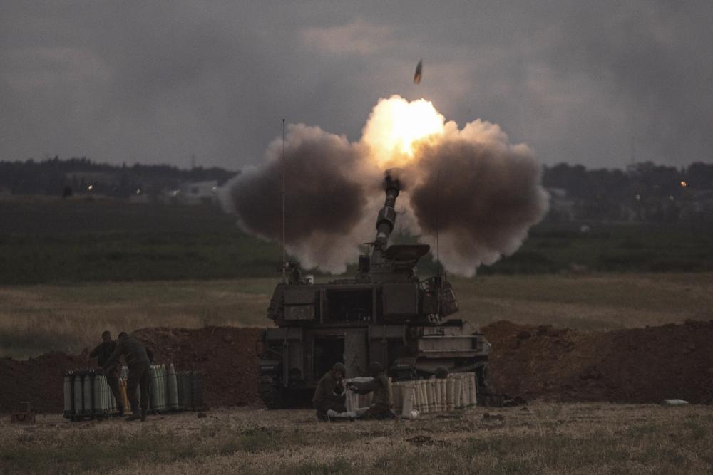 An Israeli artillery unit fires toward targets in the Gaza Strip, at the Israeli Gaza border, Monday, May 17, 2021.