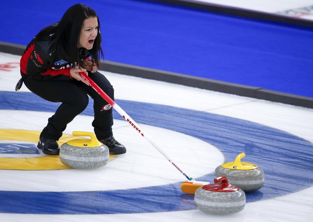 Canadian skip Kerri Einarson holds the broom for her teammates in a game against Sweden at the Women's World Curling Championships in Calgary on Saturday, May 8, 2021.