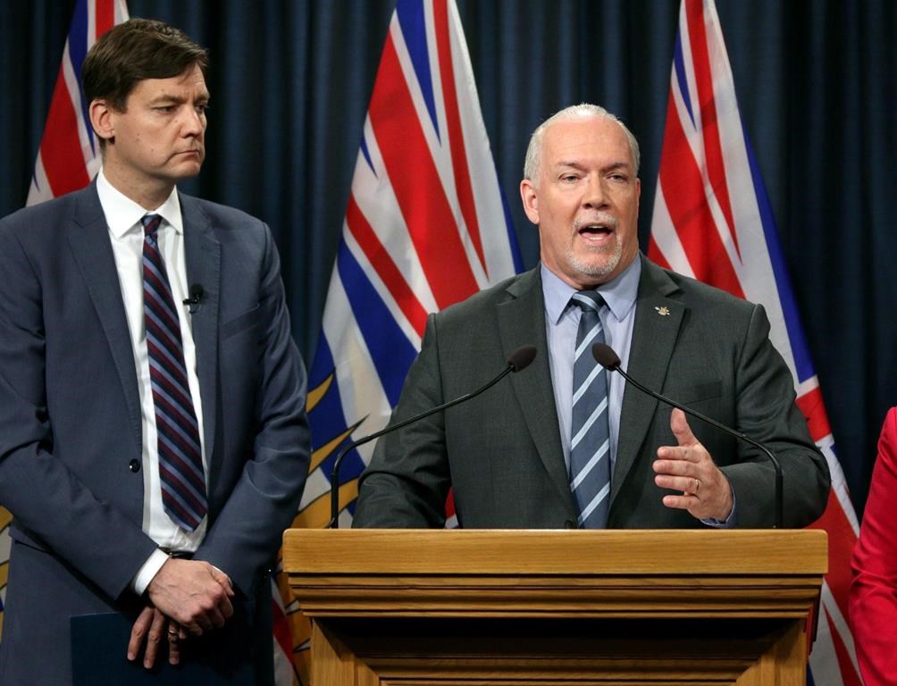 Premier John Horgan is joined by David Eby during a press conference at Legislature in Victoria, B.C., on Wednesday, May 15, 2019. Officials in Penticton, B.C., are appealing to Premier John Horgan in the latest twist related to a bitter dispute over a temporary shelter in the Okanagan city. THE CANADIAN PRESS/Chad Hipolito.