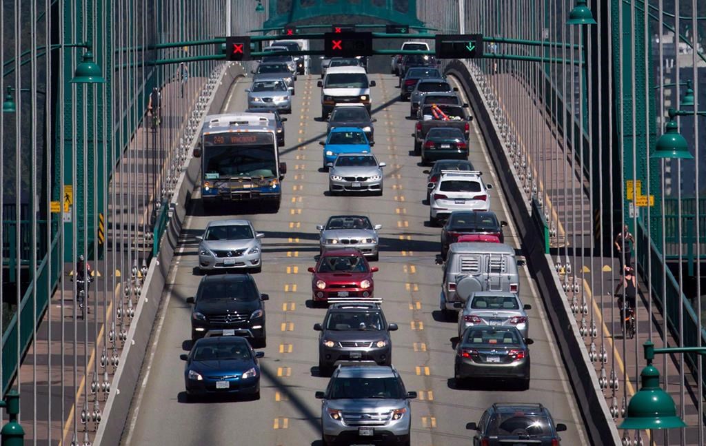 Traffic crosses over the Lions Gate Bridge from North Vancouver into Vancouver, B.C., on Thursday July 2, 2015. A project to deliver packages by cargo e-bike is about to launch in Vancouver as the city works to reduce pollution and traffic congestion. THE CANADIAN PRESS/Darryl Dyck.