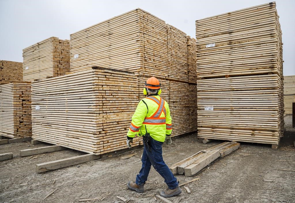 Darcy Elliott, shipping supervisor at Spray Lake Sawmills, inspects lumber at the facility in Cochrane, Alta., Thursday, May 20, 2021.