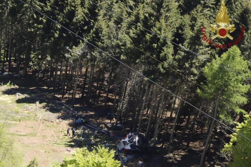 The wreckage of a cable car is seen on the ground after it collapsed near the summit of the Stresa-Mottarone line in the Piedmont region, northern Italy, Sunday, May 23, 2022. A mountaintop cable car plunged to the ground in northern Italy on Sunday, killing at least five people and sending at least three more to the hospital, authorities said.