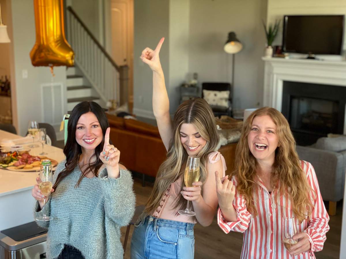Tenille Arts (middle) celebrating with songwriter Allison Veltz (left) and producer Alex Kline (right) after the trio hit No. 1