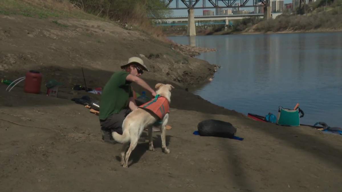 Elias Niederkorn and Tundra the dog getting ready to canoe down the North Saskatchewan River in Edmonton on May 12, 2021.