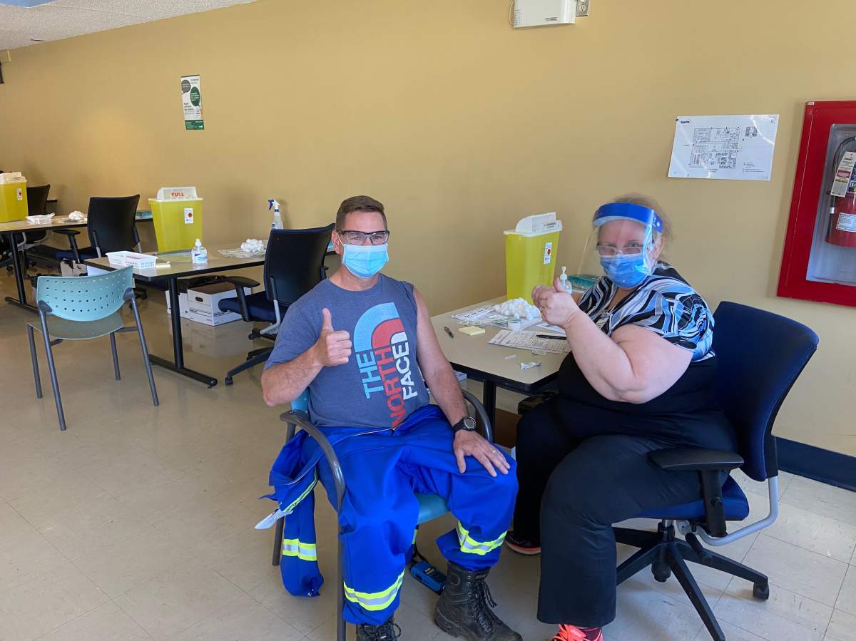An oilsands workers who was the first patient to receive a COVID-19 shot at a vaccine clinic inside the Suncor Base Plant, located north of Fort McMurray, Alta., on Monday, May 10, 2021.