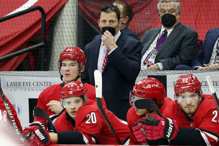 Carolina Hurricanes coach Rod Brind ‘Amour, center, watches play from behind the bench during the third period of the team’s NHL hockey game against the Detroit Red Wings in Raleigh, N.C., Thursday, April 29, 2021.