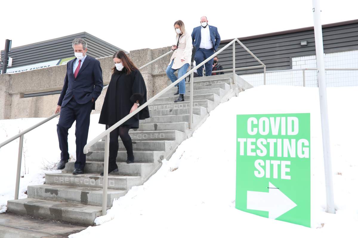 Manitoba Health Minister Heather Stefanson, second from right, walks with Premier Brian Pallister as they leave following a tour of the COVID-19 immunization supersite in Brandon. Stefanson says the province has been making plans to address rising cases and will reveal them soon.