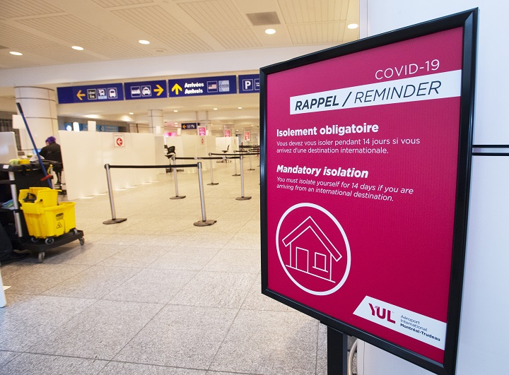 A sign reminds arriving passengers to quarantine against COVID-19 at Trudeau Airport in Montreal, Friday, Feb. 19, 2021. 