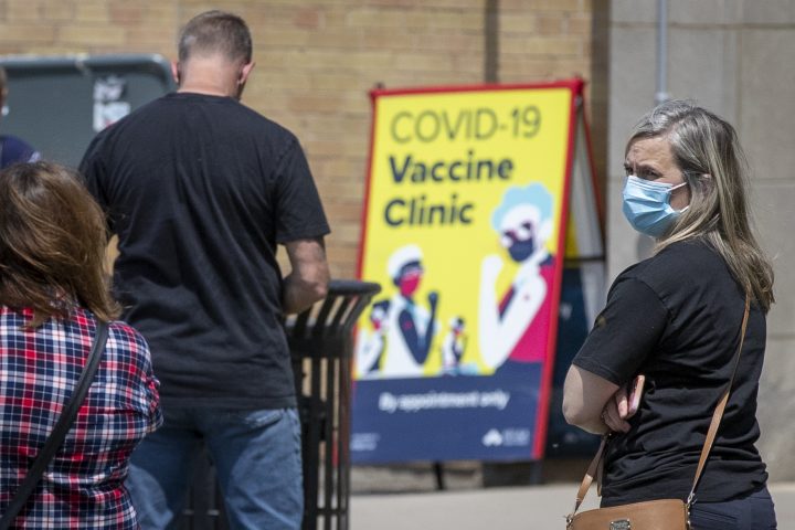 People wait in line at a COVID-19 vaccine clinic in Kingston, Ontario on Tuesday May 18, 2021.