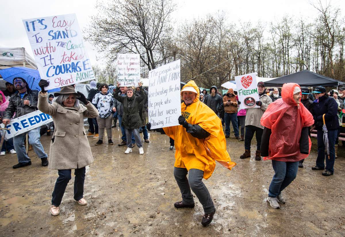 Supporters dance during a rally against provincial measures to curb the spread of COVID-19 at the Whistle Stop Café in Mirror, Alta., on Saturday, May 8, 2021.
