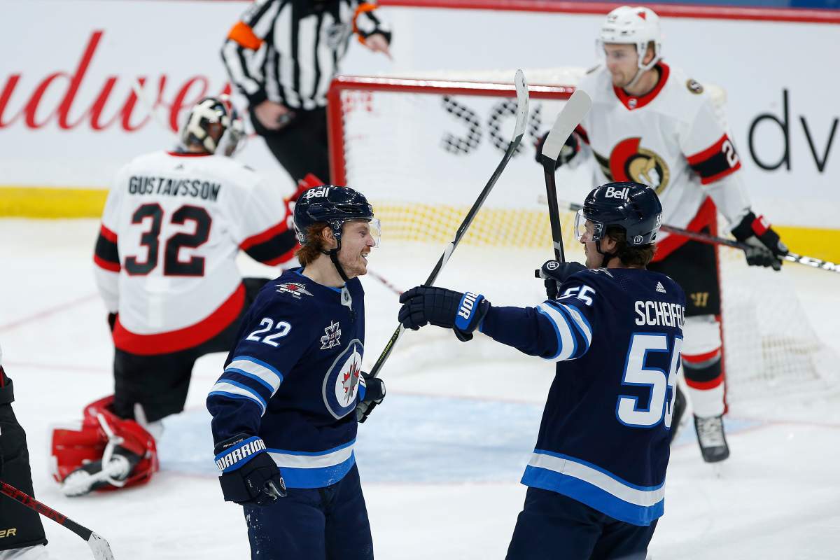 Winnipeg Jets’ Mason Appleton (22) and Mark Scheifele (55) celebrate Appleton’s goal on Ottawa Senators goaltender Filip Gustafsson (32) during second period NHL action in Winnipeg on Saturday, May 8, 2021. THE CANADIAN PRESS/John Woods