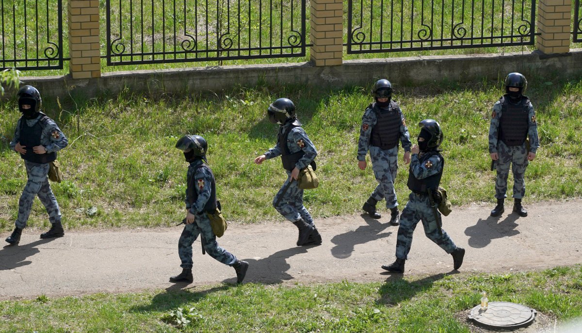 Security forces near the scene at a school after a shooting in Kazan, Russia, Tuesday, May 11, 2021. 